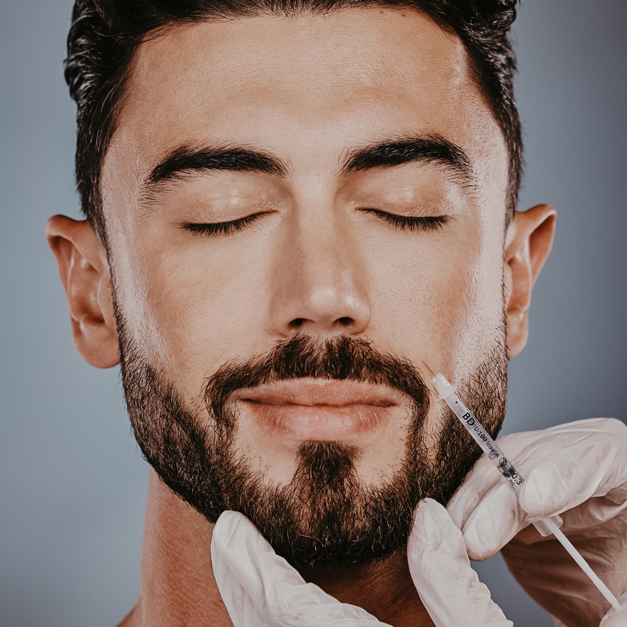 man receiving botox in his cheek
