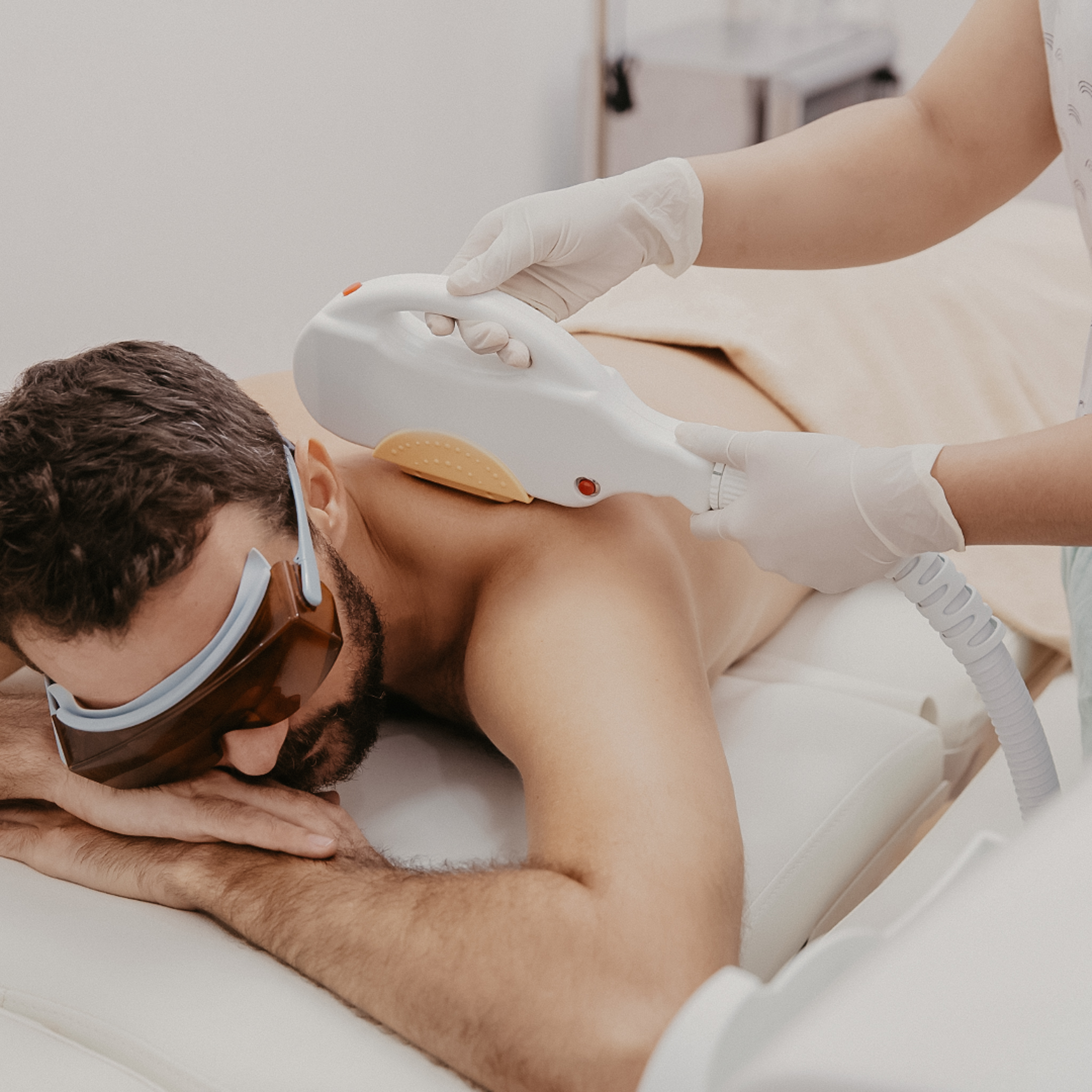 man laying down getting laser hair removal